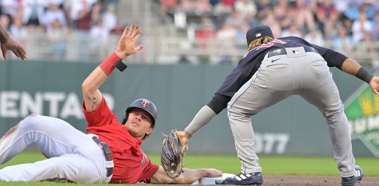 Twins right fielder Max Kepler slides in safe in front of Cleveland Guardians third baseman Jose Ramirez