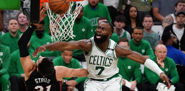 Boston Celtics guard Jaylen Brown blocks a shot by Miami Heat guard Max Strus