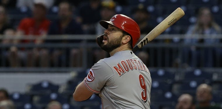 Cincinnati Reds third baseman Mike Moustakas (9) hits an RBI single in a 2021 MLB Game