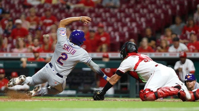 Mets first baseman Dominic Smith scores against Reds catcher Aramis Garcia